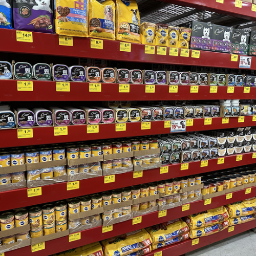 Cat food on the shelves inside of the Pet Goods store.