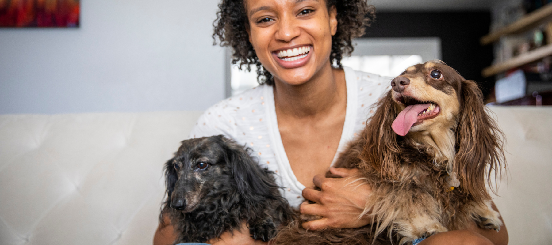 Woman holding two dogs