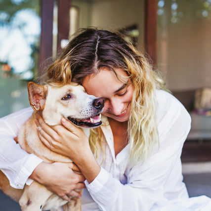 Dog Food & SuppliesOwner hugging dog